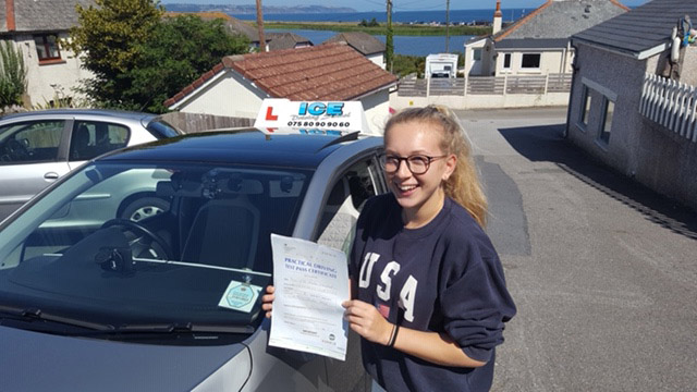 girl next to car after passing driving test in devon